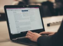 person typing on laptop computer